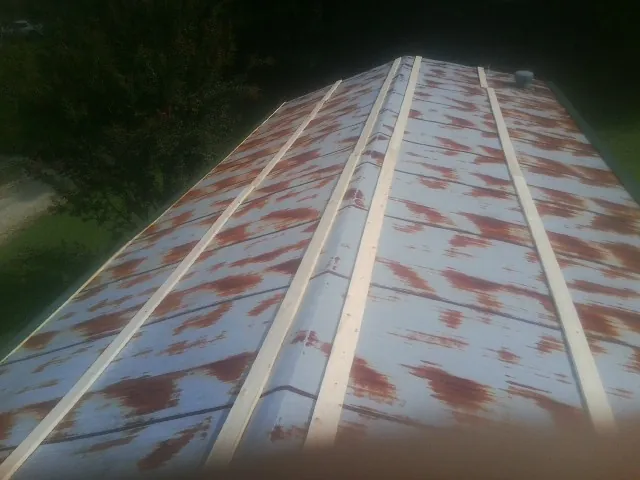 Rusted metal roof panels with new wood purlins before replacement — Storm Damage Roof Repair in Lomita by Roofing Brothers