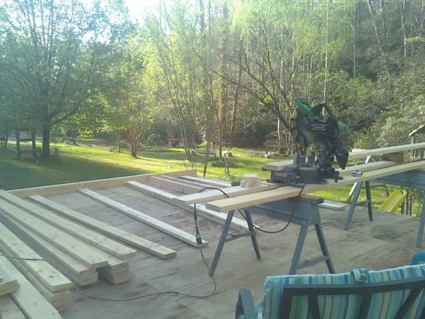 Miter saw and framing lumber on a deck under construction in Lomita